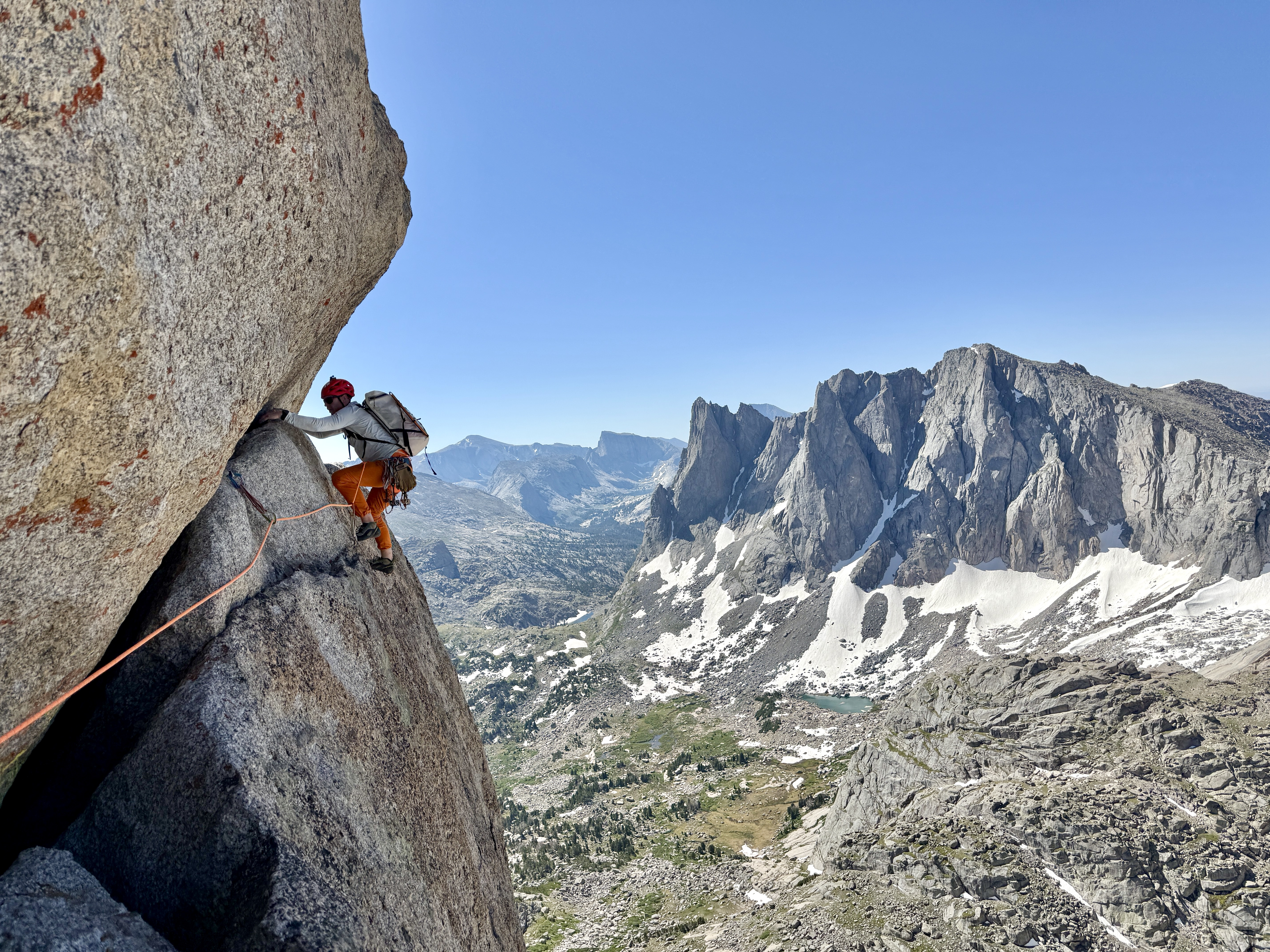 David climbing granite with mountain panorama