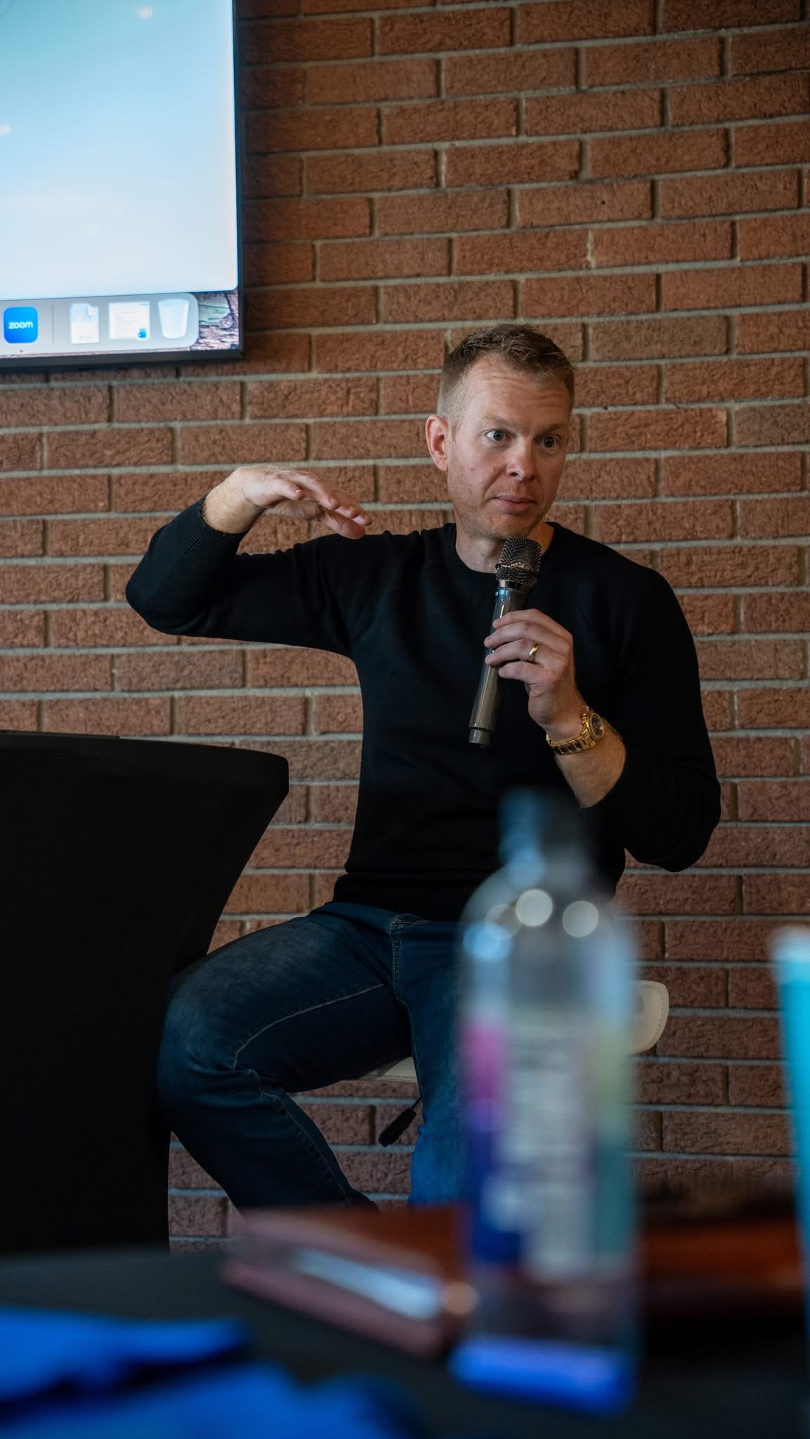 David with microphone, gesturing