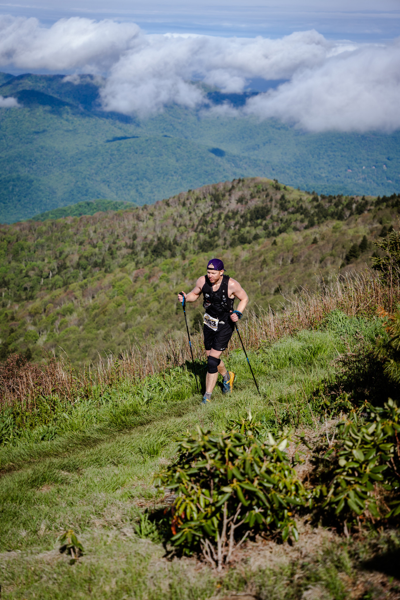 David running a mountain ridge above the clouds